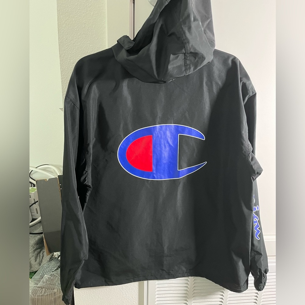 Champion size medium black windbreaker hoodie jacket. Logo sleeve. 3/4 zip